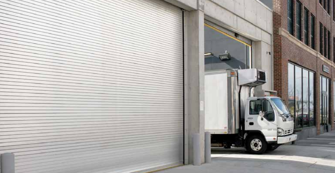 Truck leaving through roll up service door